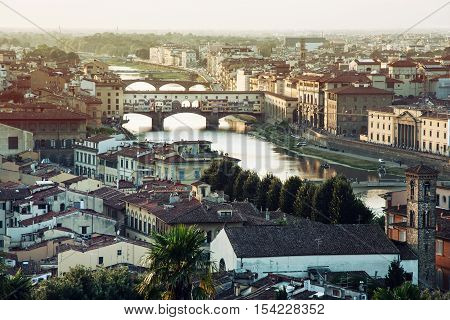 View of the city Florence with amazing bridge Ponte VecchioTuscany Italy. Sunset photo. Retro photo filter. Travel destination. Beautiful place.