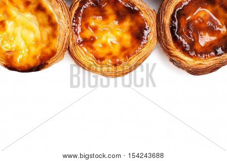 Egg Tarts isolated on white background. Heap of Typical portuguese dessert pasteis de nata close up