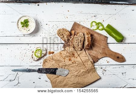Homemade bread slices and soar cream on retro wooden table