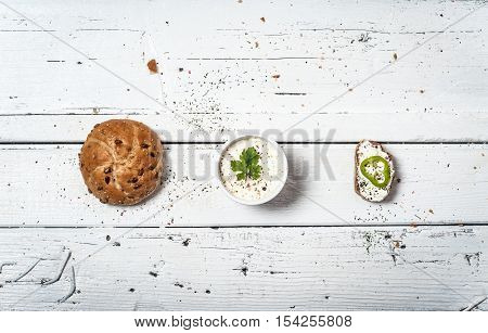 Homemade bun and soar cream on retro wooden table