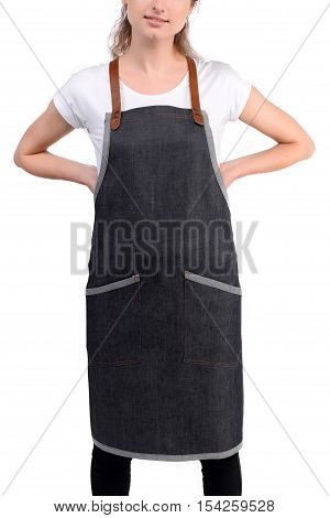 Young redhaired woman chef or waiter posing, wearing apron and white t-shirt isolated on white background