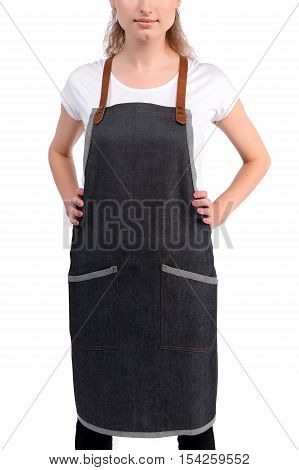 Young redhaired woman chef or waiter posing, wearing apron and white t-shirt isolated on white background