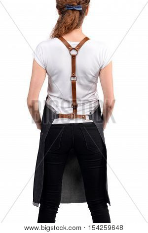 Young redhaired woman chef or waiter posing, wearing apron and white t-shirt isolated on white background