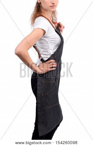 Young redhaired woman chef or waiter posing, wearing apron and white t-shirt isolated on white background