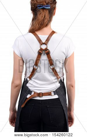 Young redhaired woman chef or waiter posing, wearing apron and white t-shirt isolated on white background