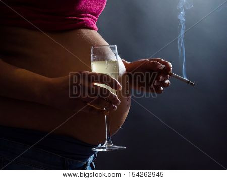 Concept of unhealthy habits during pregnancy. A pregnant woman smoking cigarette and drinking Alcohol and coffee.