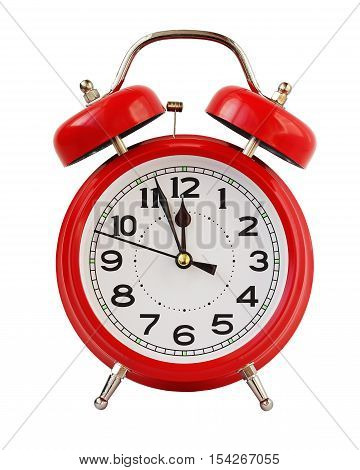 Red retro alarm clock at twelve o'clock isolated on white background. Midnight midday. Minutes about New year.