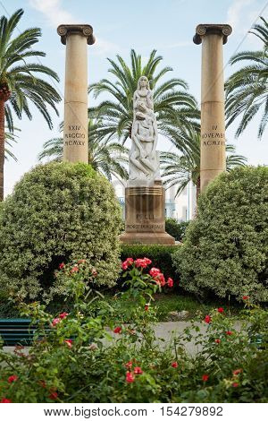 PEGLI, ITALY - AUG 7, 2016: Monument to fallen in wars. Sculpture group made of marble, base and columns of granite.