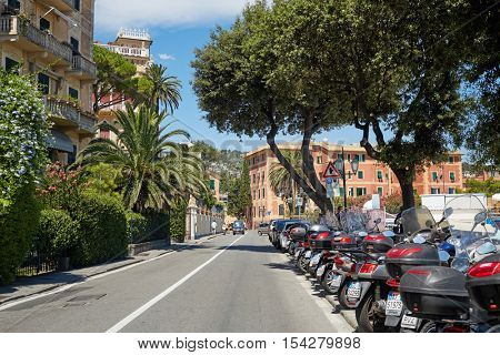PORTOFINO, ITALY - AUG 7, 2016: Daytime traffic on street of Portofino in Liguria, famous Mediterranean sea town at the Italian Riviera.
