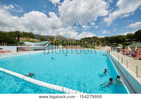 CERIALE, ITALY - AUG 05, 2016: People in swimming pool at aqua-park Caravelle. Aqua-park offers many attractions, including water slides and large swimming pools.