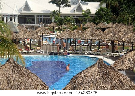 Negril Jamaica - October 15 2016. Tourists relax by the swimming pool. Exotic resort in Negril Jamaica.