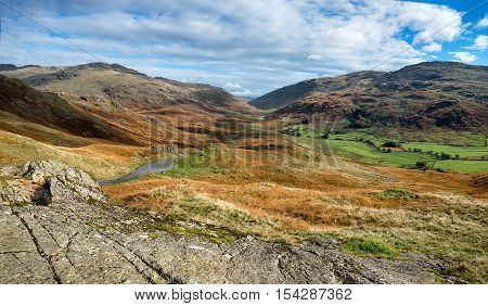 The view from the top of the Hardknott Pass in the Lake District - one of Britain's steepest and most treacherous roads with gradients of 33% and hairpin bends looking out over the Duddon Valley to the Wrynose Pass