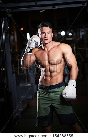 athlete in Boxing gloves standing in the gym