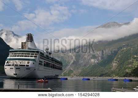 Large white cruise ship in Geirangerfjord Norway