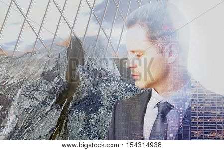 Sad pensive businessman behind iron wire mesh on landscape background. Freedom concept