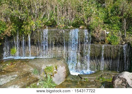 Mountain spring waterfall the azure river. Georgia, Europe.