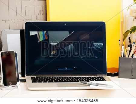PARIS FRANCE - OCT 28 2016: Apple Computers website on new MacBook Pro Retina with OLED Touch bar in geek creative room showcasing Apple Keynote presentation of Jhony Ive presenting the new laptop film
