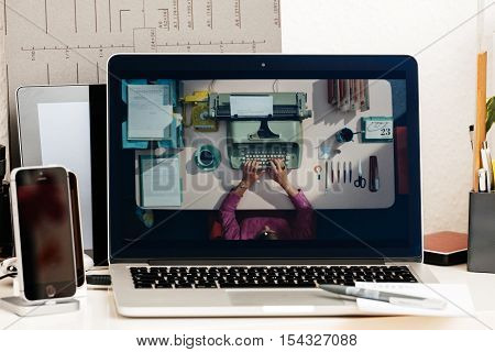 PARIS FRANCE - OCT 28 2016: Apple Computers website on new MacBook Pro Retina with OLED Touch bar in geek creative room showcasing Apple Keynote presentation of evolution of typewriting machines and laptops