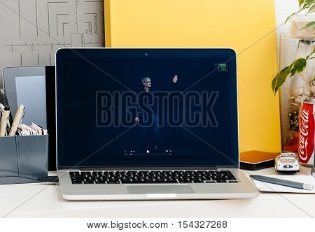 PARIS FRANCE - OCT 28 2016: Apple Computers website on new MacBook Pro Retina with OLED Touch bar in geek creative room showcasing Apple Keynote presentation of Tim Cook saluting audience