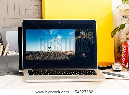 PARIS FRANCE - OCT 28 2016: Apple Computers website on new MacBook Pro Retina with OLED Touch bar in geek creative room showcasing Apple Keynote presentation of iPhone 7 plus photographs by Tim Cook