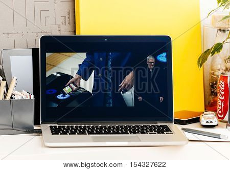 PARIS FRANCE - OCT 28 2016: Apple Computers website on new MacBook Pro Retina with OLED Touch bar in geek creative room showcasing Apple Keynote presentation of Apple Pay in Japan by Tim Cook