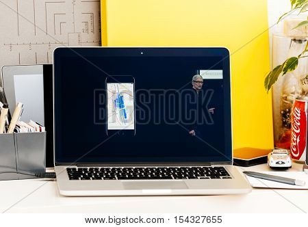PARIS FRANCE - OCT 28 2016: Apple Computers website on new MacBook Pro Retina with OLED Touch bar in geek creative room showcasing Apple Keynote presentation of detailed maps of transportationin Japan