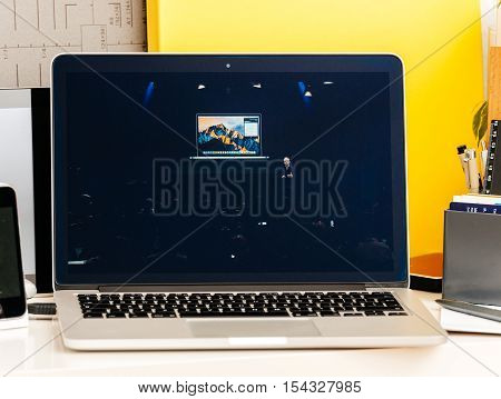 PARIS FRANCE - OCT 28 2016: Apple Computers website on new MacBook Pro Retina with OLED Touch bar in geek creative room showcasing Apple Keynote presentation of Tim Cook talking about Macbook Pro