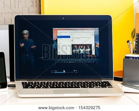 PARIS FRANCE - OCT 28 2016: Apple Computers website on new MacBook Pro Retina with OLED Touch bar in geek creative room showcasing Apple Keynote presentation Craig Federighi talking about new MacBook Pro
