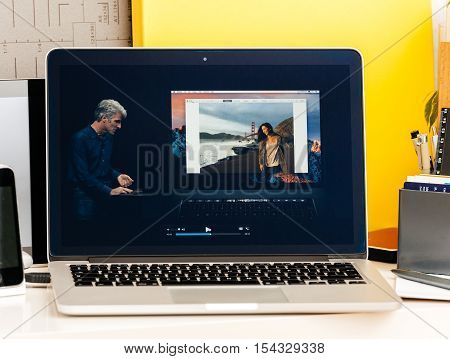 PARIS FRANCE - OCT 28 2016: Apple Computers website on new MacBook Pro Retina with OLED Touch bar in geek creative room showcasing Apple Keynote presentation Craig Federighi talking about new MacBook Pro