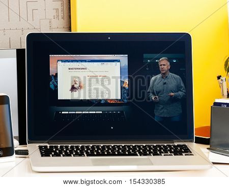 PARIS FRANCE - OCT 28 2016: Apple Computers website on new MacBook Pro Retina with OLED Touch bar in geek creative room showcasing Apple Keynote presentation of Philip Schiller inegration software