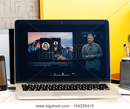PARIS FRANCE - OCT 28 2016: Apple Computers website on new MacBook Pro Retina with OLED Touch bar in geek creative room showcasing Apple Keynote presentation of Philip Schiller inegration software