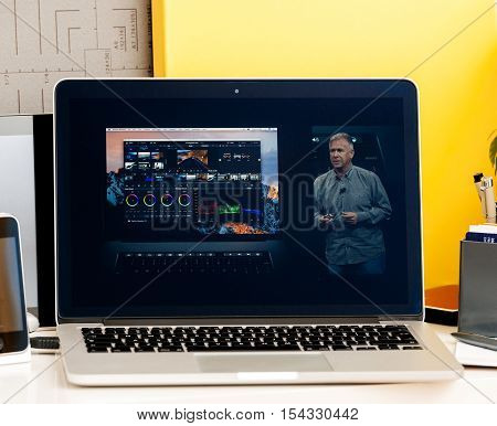 PARIS FRANCE - OCT 28 2016: Apple Computers website on new MacBook Pro Retina with OLED Touch bar in geek creative room showcasing Apple Keynote presentation of Philip Schiller inegration software