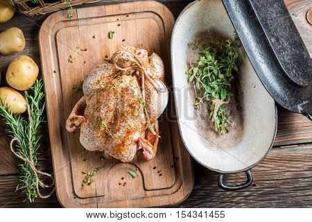 Chicken with herbs and vegetables ready to roast