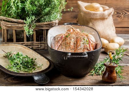 Chicken in casserole dish spiced with herbs