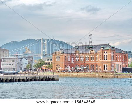 Fukuoka, Japan - July 17, 2016: Old Moji Customs Office, built in 1912 at Moji port in Kitakyushu, Fukuoka , Japan. In the building has a coffee shop and art gallery. Kanmonkyo Bridge on background.