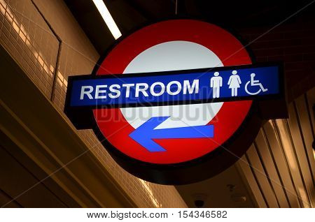 White and red and blue restroom sign