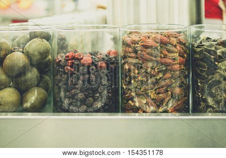 passion fruit hibiscus sabdariffa and date-plum in bottle at morning market. street food