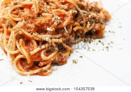 Close-up of spaghetti on white plain plate - copy space