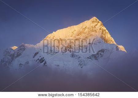 Last golden light before sunset at Lhotse-Everest Mountain. During the way to Everest base camp. Sagarmatha national park. Nepal.