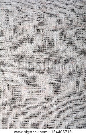 The texture of coarse cloth. Sackcloth. Eco fabric. Natural fabric. The folds of the fabric. Background.