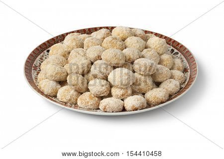 Dish with traditional Moroccan coconut cookies on white background