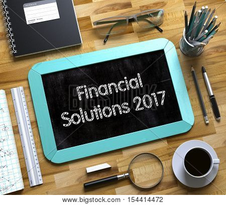Financial Solutions 2017 - Text on Small Chalkboard.Top View of Office Desk with Stationery and Mint Small Chalkboard with Business Concept - Financial Solutions 2017. 3d Rendering.