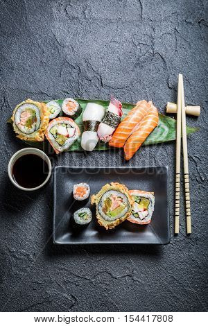 Sushi on the black ceramic dish on black rock