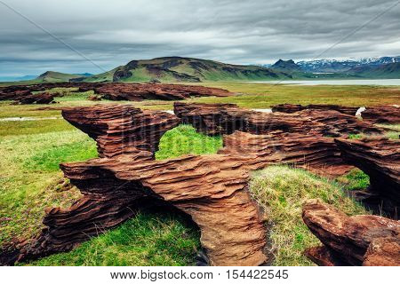 Sandy rocks with by magma formed by winds. Popular tourist attraction. Unusual and gorgeous scene. Location Sudurland, cape Dyrholaey, south coast of Iceland, Europe. Artistic picture. Beauty world.