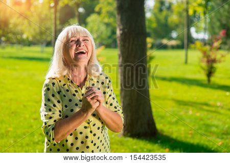 Elderly woman laughing. Happy lady outdoor. Greatest joy in life. All troubles left behind.