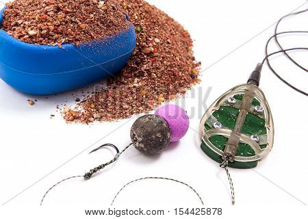 Dry Feed For Carp Fishing. Ready For Use Carp Bait With Fishing Flat Feeder For Carp Fishing Isolate