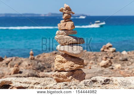 Pyramid of the stones. Close up photo of the little pyramid made of sea stones on the Mallorca coast Spain.