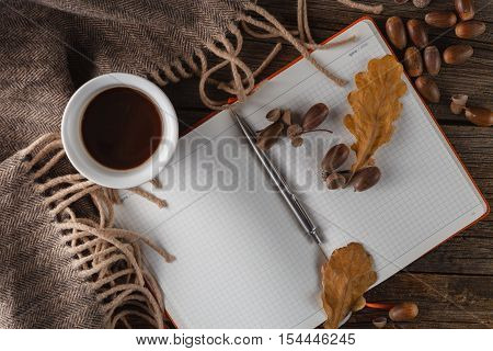 coffee mugs in autumn background with notebok