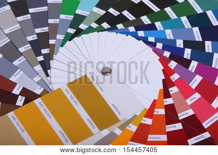 collection of ral colours on wooden background. colored paper