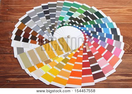 collection of ral colours on wooden background. colored paper